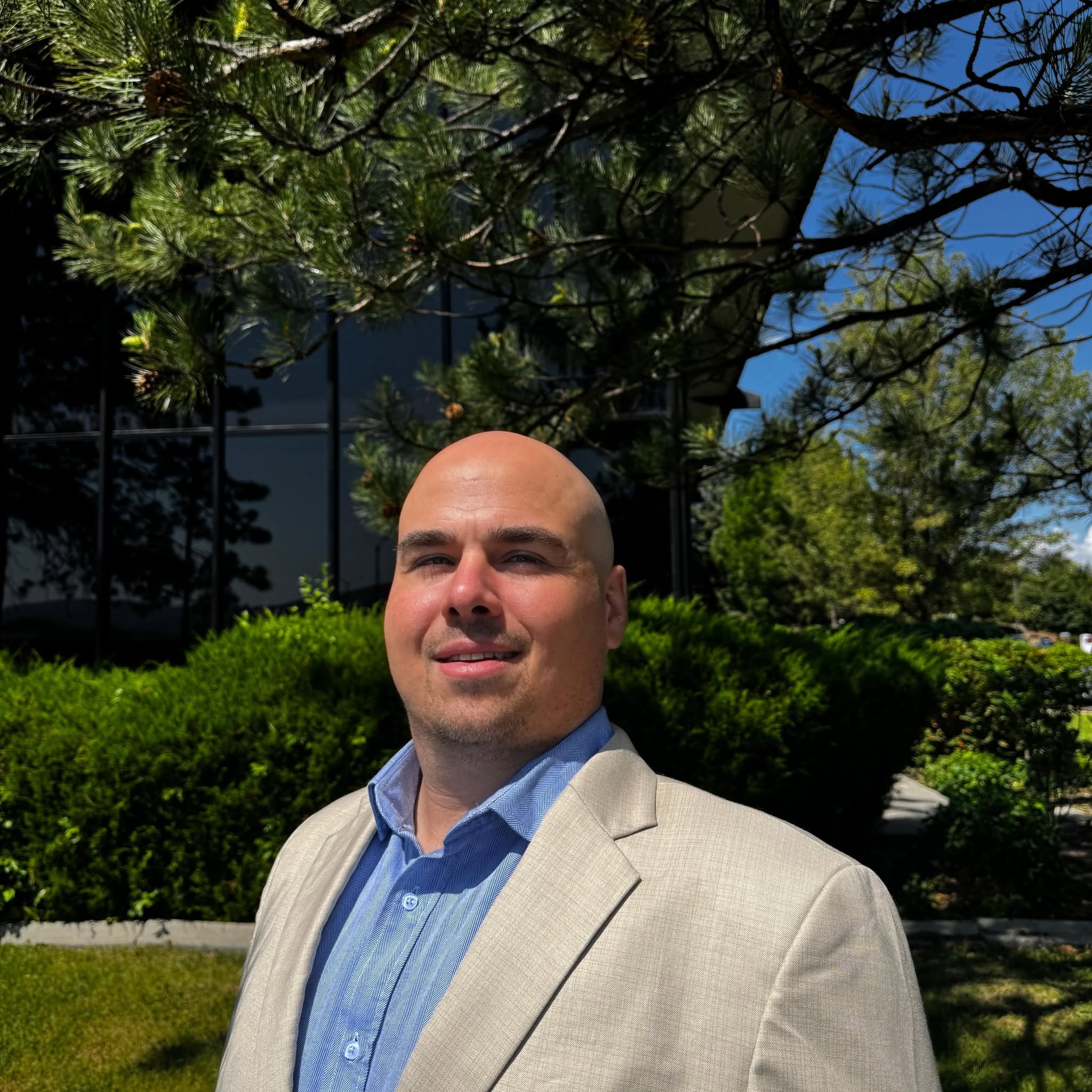 Michael Williamson, co-founder of Williamson Price Modern Wealth, standing outdoors in professional attire.